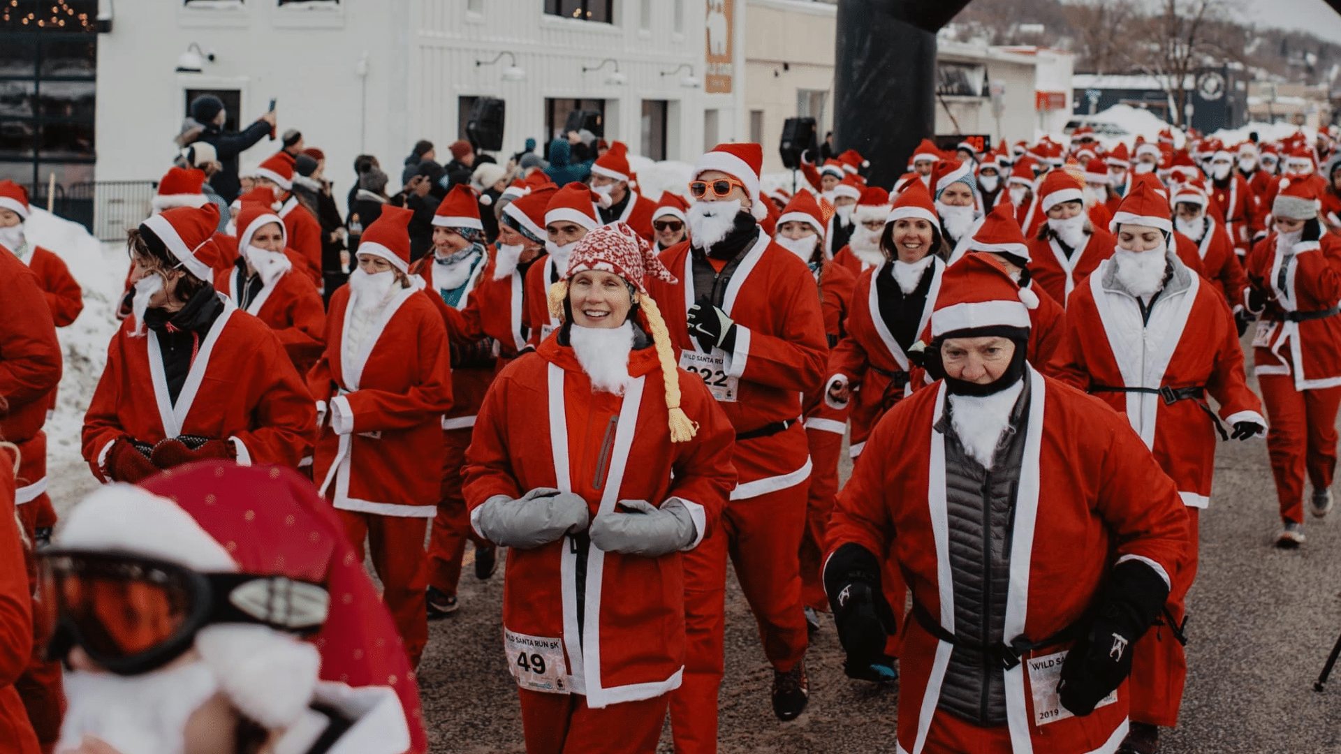 people dressed up in santa suits running